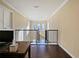 Hallway with hardwood floors, white trim, and view of windows at the end of the hall at 3687 Farm Bell Pl, Lake Mary, FL 32746
