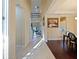Inviting hallway with tile and hardwood floors, leading to a dining area and staircase at 3687 Farm Bell Pl, Lake Mary, FL 32746