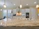 Spacious kitchen with white cabinets, a large island, and stainless steel appliances at 3687 Farm Bell Pl, Lake Mary, FL 32746