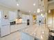 Spacious kitchen featuring white cabinets, stainless steel appliances, and a large center island at 3687 Farm Bell Pl, Lake Mary, FL 32746