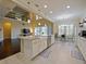 Bright kitchen with island, stainless appliances, farmhouse sink, and breakfast nook near large windows at 3687 Farm Bell Pl, Lake Mary, FL 32746