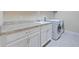 Functional laundry room with modern washer, dryer, spacious countertops, and ample storage at 3687 Farm Bell Pl, Lake Mary, FL 32746
