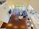 Aerial view of an open-concept living room with hardwood floors, high ceilings, and large windows at 3687 Farm Bell Pl, Lake Mary, FL 32746
