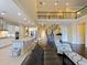 Open-concept living area showcasing the kitchen, living room, and staircase with a wrought iron railing at 3687 Farm Bell Pl, Lake Mary, FL 32746