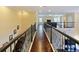 The spacious loft offers dark wood floors and black iron railings overlooking the living area and bedrooms at 3687 Farm Bell Pl, Lake Mary, FL 32746