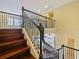 A staircase with dark wood steps and detailed black iron railing leads to the second level of the home at 3687 Farm Bell Pl, Lake Mary, FL 32746