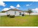 A spacious backyard offers a well-maintained lawn, a small patio and a white fence at 3807 Night Heron Dr, Sanford, FL 32773