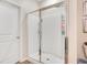 Bathroom featuring a glass-enclosed shower, a white door, and a neutral color palette at 3807 Night Heron Dr, Sanford, FL 32773