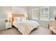 Bright bedroom features a plush bed with a woven headboard and shuttered windows at 3807 Night Heron Dr, Sanford, FL 32773