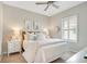 Serene bedroom showcases a neatly arranged bed, ambient lighting, and shuttered windows at 3807 Night Heron Dr, Sanford, FL 32773