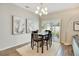 Dining room with a dark wood table, seating for four, and an elegant chandelier at 3807 Night Heron Dr, Sanford, FL 32773