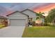 Charming single-Gathering home featuring a manicured lawn, two-car garage, and lovely landscaping at 3807 Night Heron Dr, Sanford, FL 32773