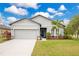 Charming single-Gathering home featuring a manicured lawn, two-car garage, and lovely landscaping at 3807 Night Heron Dr, Sanford, FL 32773
