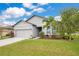 Charming single-Gathering home featuring a manicured lawn, two-car garage, and lovely landscaping at 3807 Night Heron Dr, Sanford, FL 32773