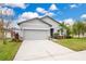 Charming single-Gathering home featuring a manicured lawn, two-car garage, and lovely landscaping at 3807 Night Heron Dr, Sanford, FL 32773
