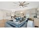 Spacious living room featuring a comfortable gray sofa, ottoman, and modern ceiling fan at 3807 Night Heron Dr, Sanford, FL 32773