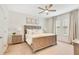 Comfortable main bedroom showcases a wooden bed frame, decorative lamps, and neutral decor at 3807 Night Heron Dr, Sanford, FL 32773
