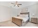 Comfortable main bedroom showcases a wooden bed frame, decorative lamps, and neutral decor at 3807 Night Heron Dr, Sanford, FL 32773