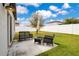View of the patio and backyard with seating for relaxing and a white fence on the property line at 3807 Night Heron Dr, Sanford, FL 32773