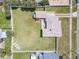 Birds-eye view of a property with lush green yard and a charming fenced-in outdoor space at 385 Woodland Ave, Daytona Beach, FL 32118