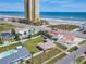 Gorgeous aerial view of a beach house with a spacious fenced yard, pool, and nearby ocean access at 385 Woodland Ave, Daytona Beach, FL 32118