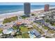 Scenic aerial shot of a charming neighborhood by the sea, highlighting the proximity to the beach and local amenities at 385 Woodland Ave, Daytona Beach, FL 32118