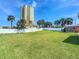 Expansive backyard space with tall condo building in the background at 385 Woodland Ave, Daytona Beach, FL 32118