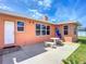 Exterior view of the home's backyard patio area with seating at 385 Woodland Ave, Daytona Beach, FL 32118