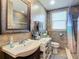 Updated bathroom featuring a vanity sink, toilet, mirror and tiled shower at 385 Woodland Ave, Daytona Beach, FL 32118