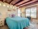 Comfortable bedroom with natural light, tile floors, charming decor, and a cozy seating area at 385 Woodland Ave, Daytona Beach, FL 32118