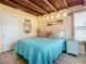Bright bedroom featuring wood ceilings, blue quilt, and beach themed decor at 385 Woodland Ave, Daytona Beach, FL 32118