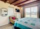 Bright bedroom with wood ceilings, tiled floors, TV, chair and window with blinds at 385 Woodland Ave, Daytona Beach, FL 32118