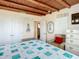 Charming bedroom featuring wood beam ceilings, blue and white quilt, and beach decor at 385 Woodland Ave, Daytona Beach, FL 32118