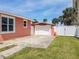 Rear exterior view of the detached garage and driveway area at 385 Woodland Ave, Daytona Beach, FL 32118