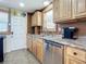 Cozy kitchen featuring light wood cabinets, stainless steel appliances, and cute fish decor accents at 385 Woodland Ave, Daytona Beach, FL 32118