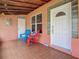 Charming front porch with colorful chairs and decorative accents offering a welcoming entrance at 385 Woodland Ave, Daytona Beach, FL 32118