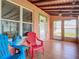 Charming sunroom featuring tile flooring, cozy seating, and plenty of natural light at 385 Woodland Ave, Daytona Beach, FL 32118