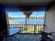 Relaxing balcony with seating and stunning views of the serene lake at 400 E Orlando Ave # 10 C, Ocoee, FL 34761