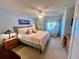 Bedroom with a chair near the window, dresser, ceiling fan, and decor at 400 E Orlando Ave # 10 C, Ocoee, FL 34761