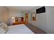 Cozy bedroom featuring a TV, wood dresser, and mirror over the queen-sized bed at 400 E Orlando Ave # 10 C, Ocoee, FL 34761