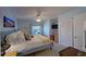 Bright bedroom features a ceiling fan, built-in desk, and a view of the outdoors at 400 E Orlando Ave # 10 C, Ocoee, FL 34761