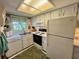 Bright kitchen featuring white appliances and plenty of counter space at 400 E Orlando Ave # 10 C, Ocoee, FL 34761