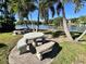 Picnic area with tile table and seating with lake views and palm trees in the landscaping at 400 E Orlando Ave # 10 C, Ocoee, FL 34761