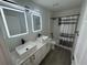 Modern bathroom with double vanity, vessel sinks, and LED-lit mirrors at 403 Britten Dr, Kissimmee, FL 34758