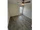 Bedroom featuring light grey vinyl flooring, fan, and bright window at 403 Britten Dr, Kissimmee, FL 34758
