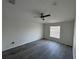 Bedroom featuring light grey vinyl flooring, fan, and bright window at 403 Britten Dr, Kissimmee, FL 34758