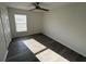 Bedroom featuring light grey vinyl flooring, fan, and bright window at 403 Britten Dr, Kissimmee, FL 34758