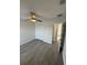 Bedroom featuring light gray vinyl flooring, fan, and large closet at 403 Britten Dr, Kissimmee, FL 34758
