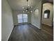 Bright dining room featuring modern light fixtures and sleek, gray laminate flooring at 403 Britten Dr, Kissimmee, FL 34758