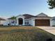 Charming single-story home with a well-manicured lawn and a cozy, inviting entrance at 403 Britten Dr, Kissimmee, FL 34758